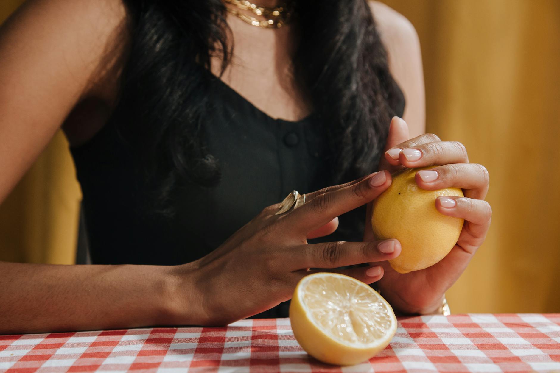 Woman holding colorful silicone vibrators with contemplative expression