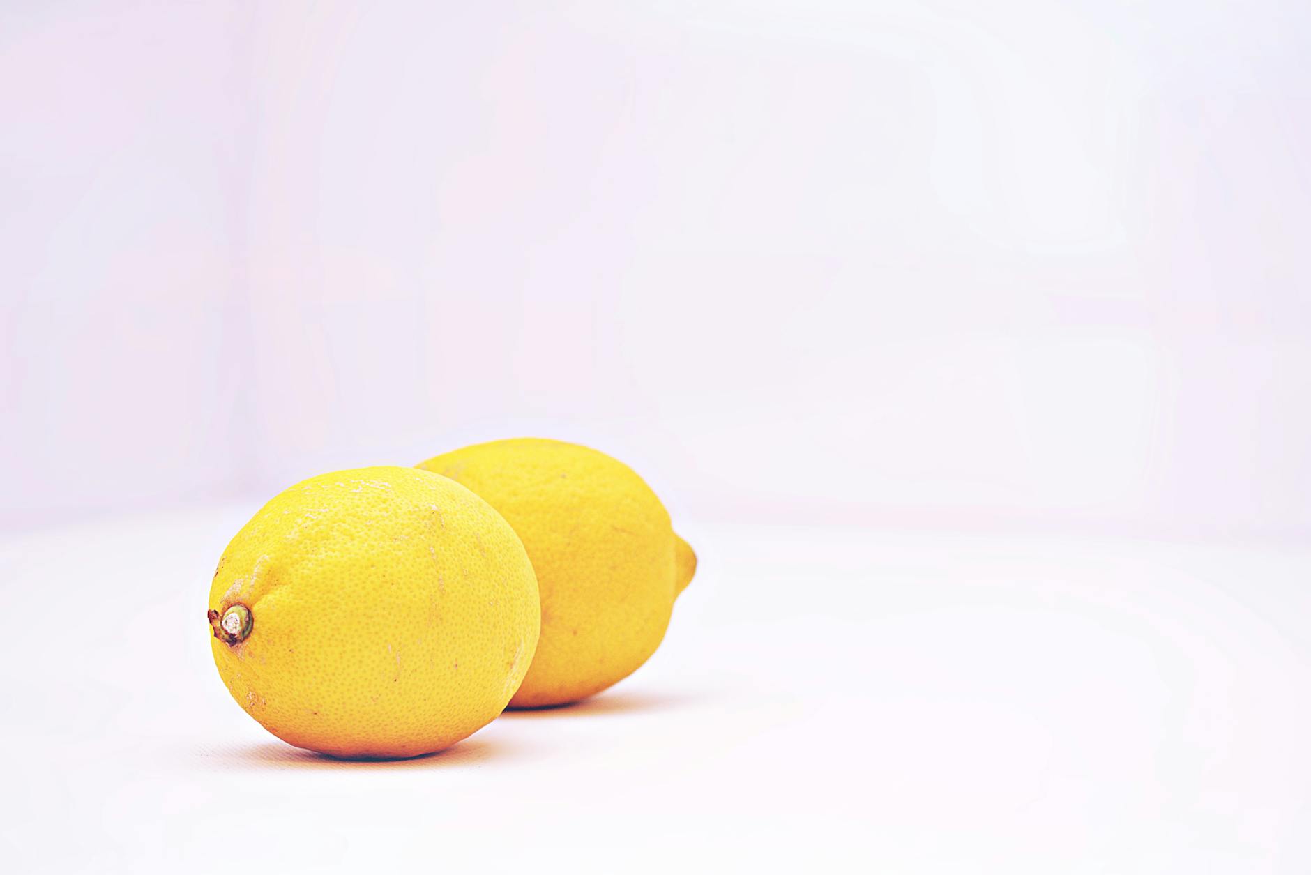 Studio arrangement of colorful sex toys on a bright yellow background, demonstrating diverse clitoral vibrator designs and shapes