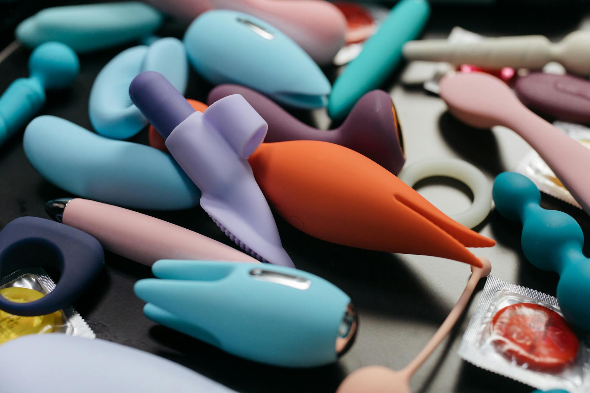 A blue silicone clitoral vibrator held in hand, symbolizing self-exploration and pleasure