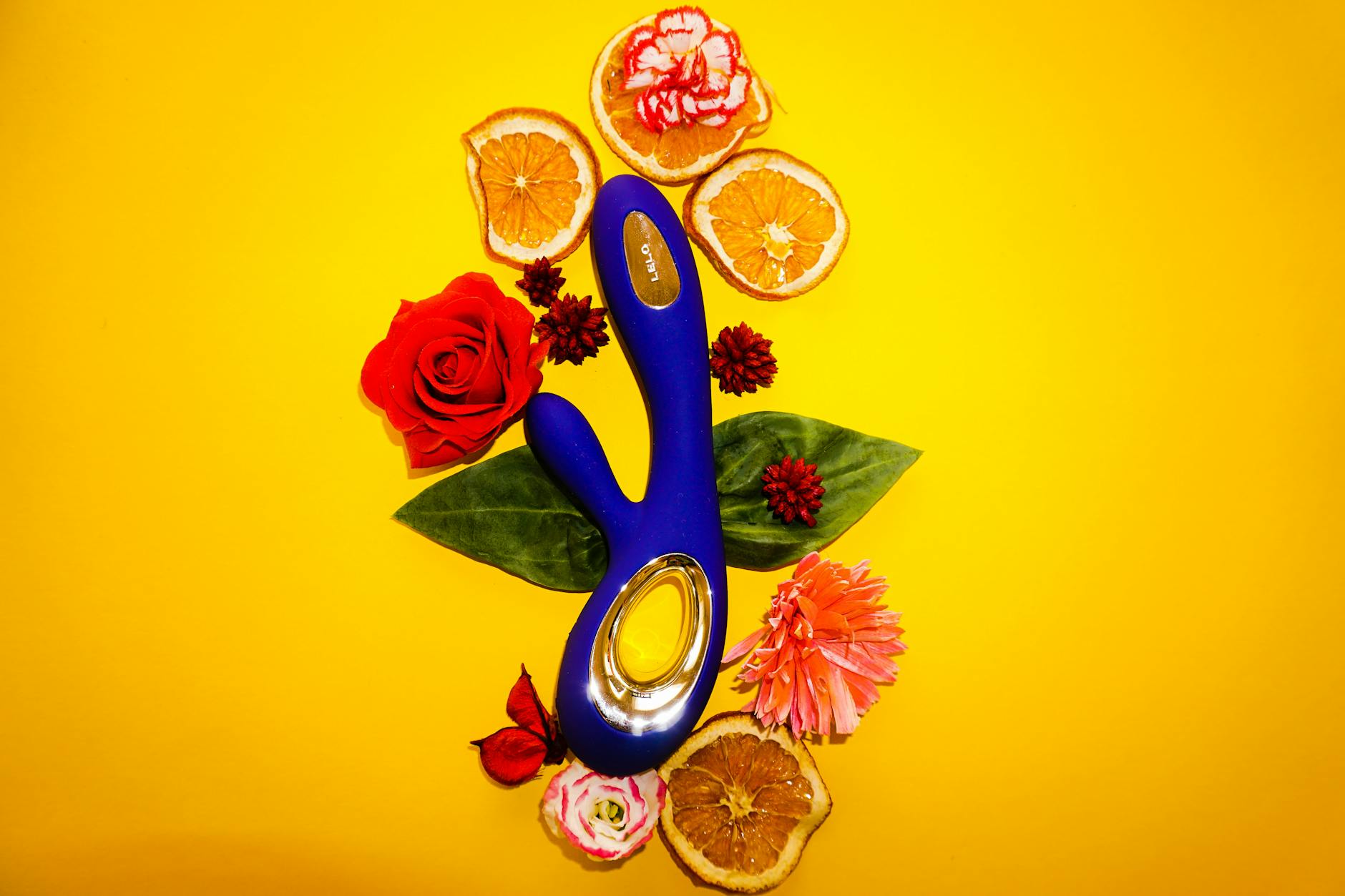 A blue lemon vibrator held in hand against a purple background, symbolizing self-directed pleasure